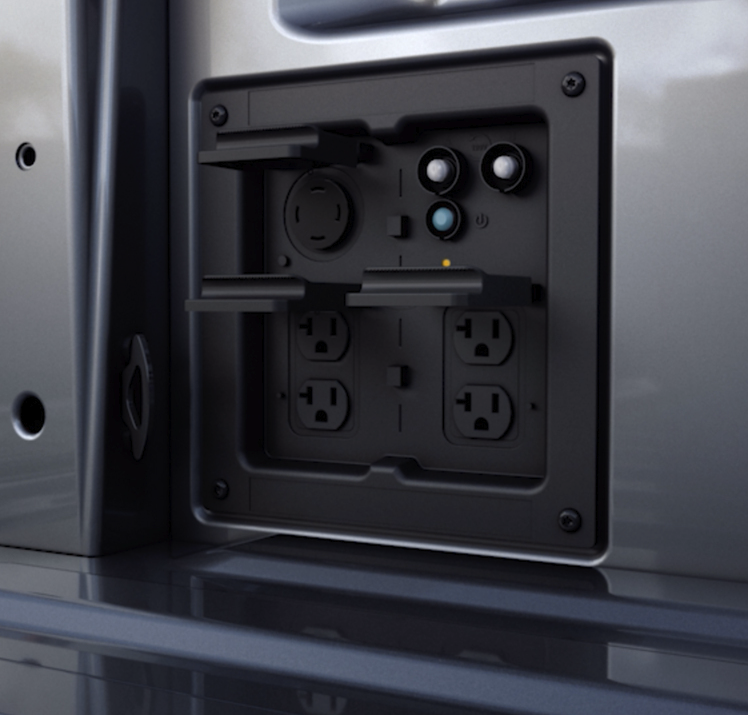 A Ford Pro Power Onboard outlet panel in the bed of a pickup truck.