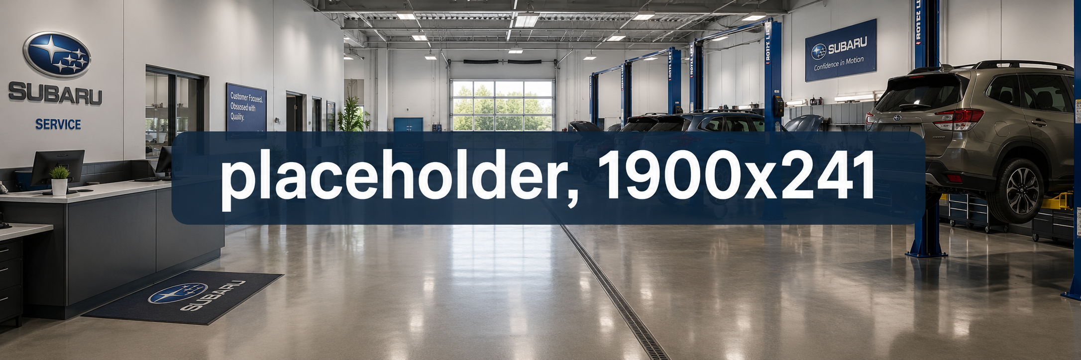 Clean Subaru service center garage featuring polished floors, customer service desk, and vehicles on hydraulic lifts.