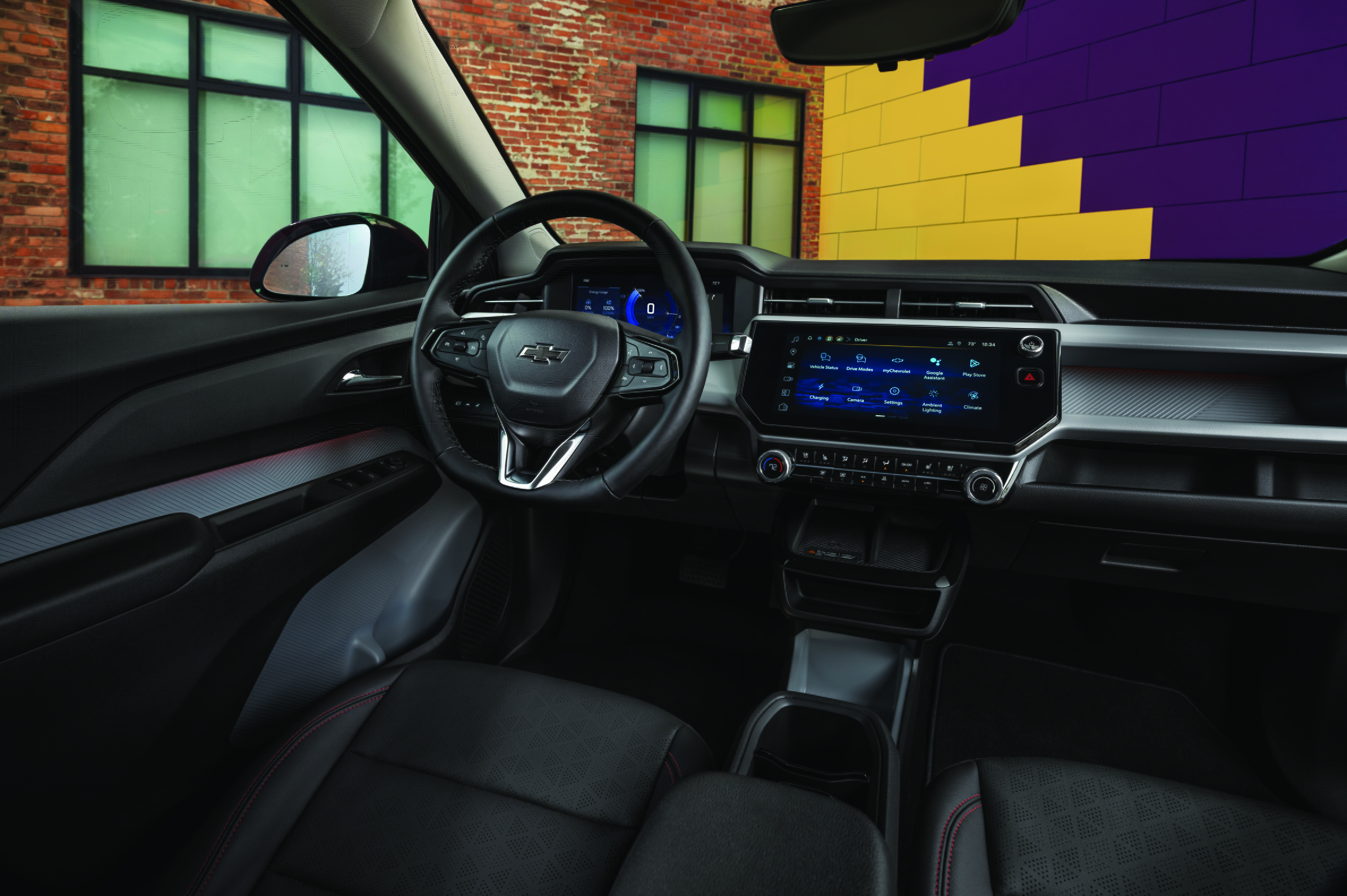 Interior view of a modern Chevrolet vehicle featuring a digital dashboard, large touchscreen, and black leather seats.