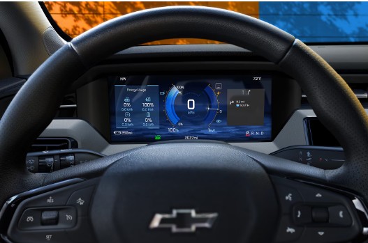 Digital dashboard of a Chevrolet vehicle showing energy usage, speed, and navigation through a steering wheel.