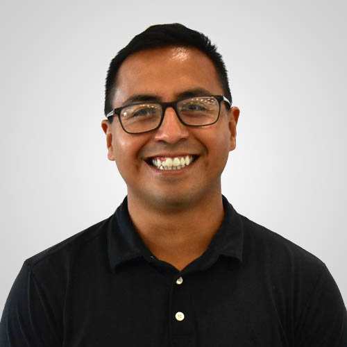 Smiling man with short dark hair and glasses wearing a black polo shirt.
