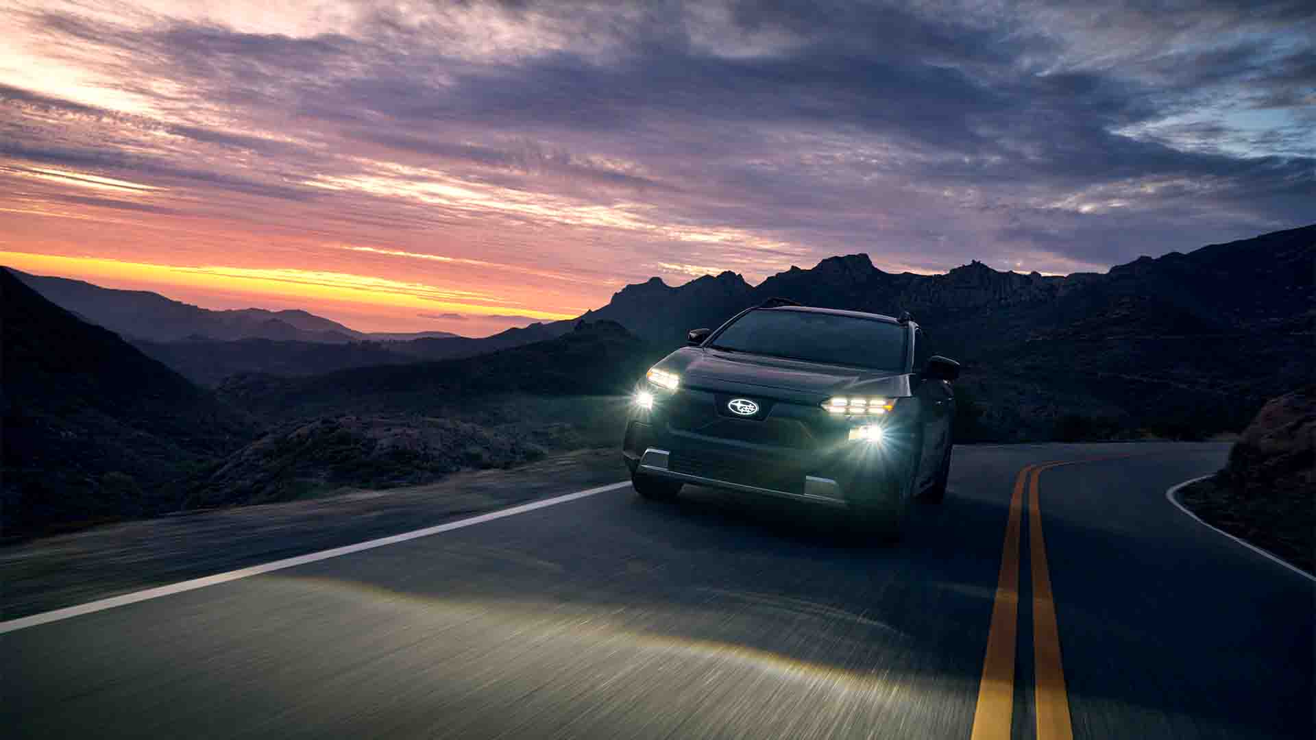 A conceptual rendering of the 2026 Subaru Trailseeker traversing a rugged mountain ridge during sunrise