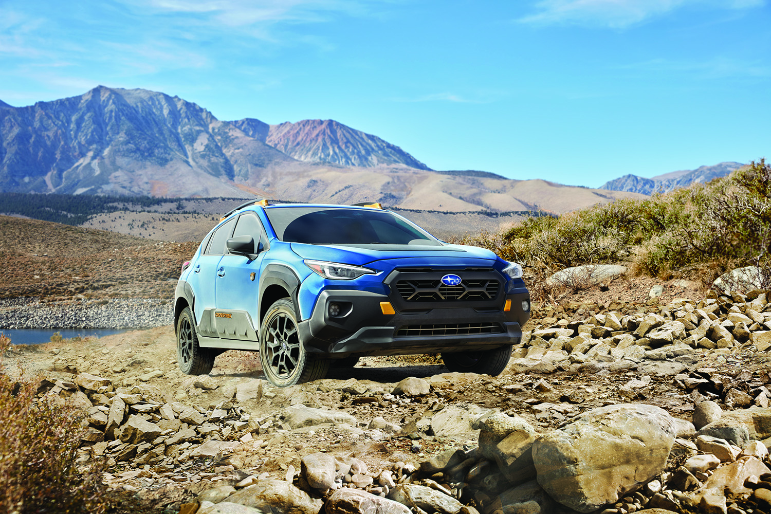 A 2026 Subaru Crosstrek Wilderness navigating a muddy trail with its increased ground clearance visible.