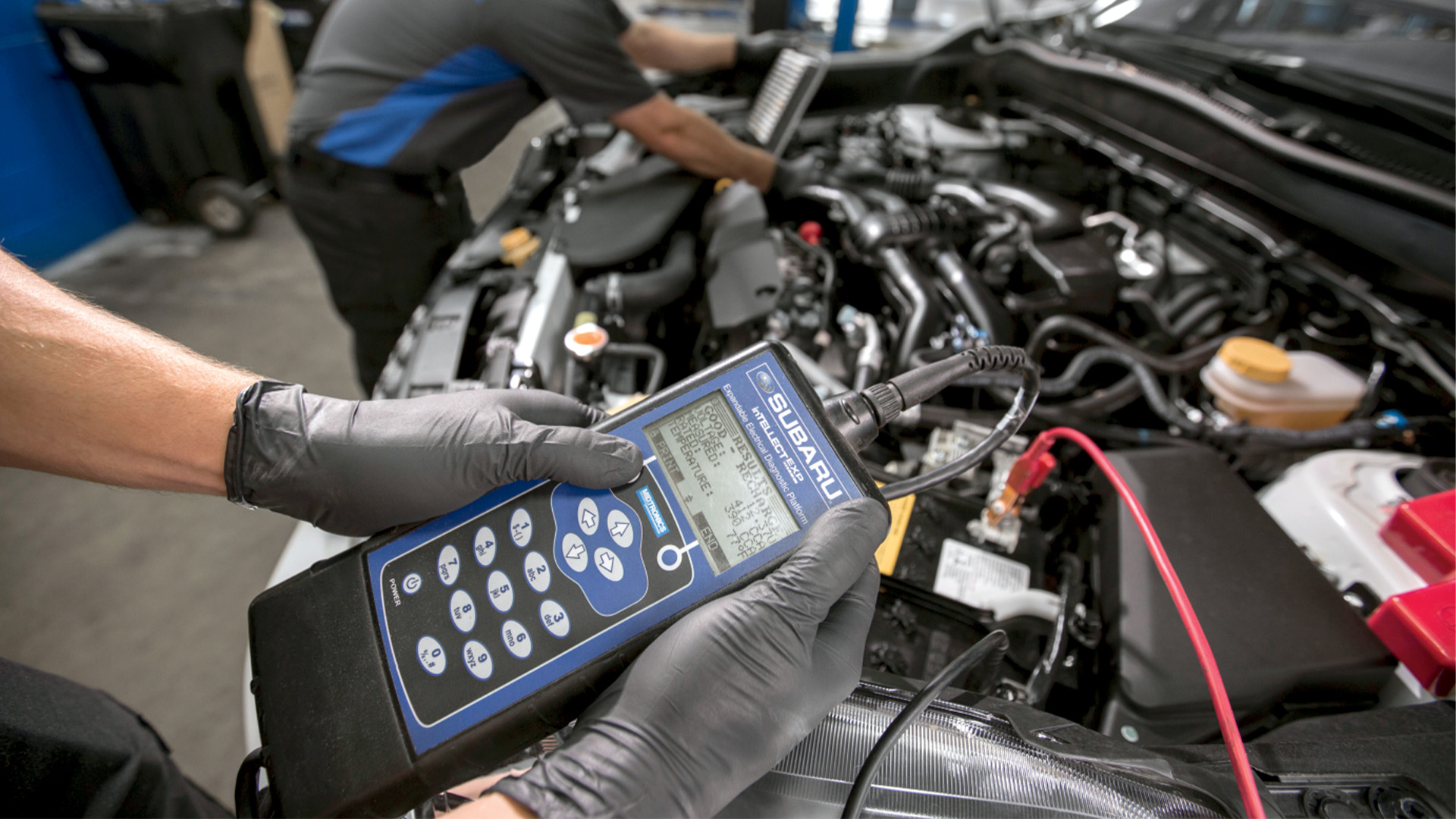 A technician using a Subaru Select Monitor to scan vehicle systems