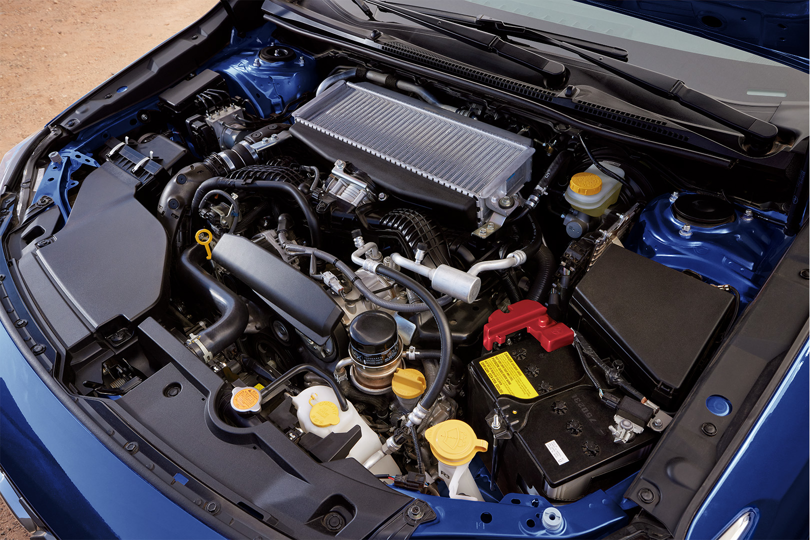 Close-up of the 2.4-liter turbocharged BOXER engine highlighting the intercooler and symmetrical layout.