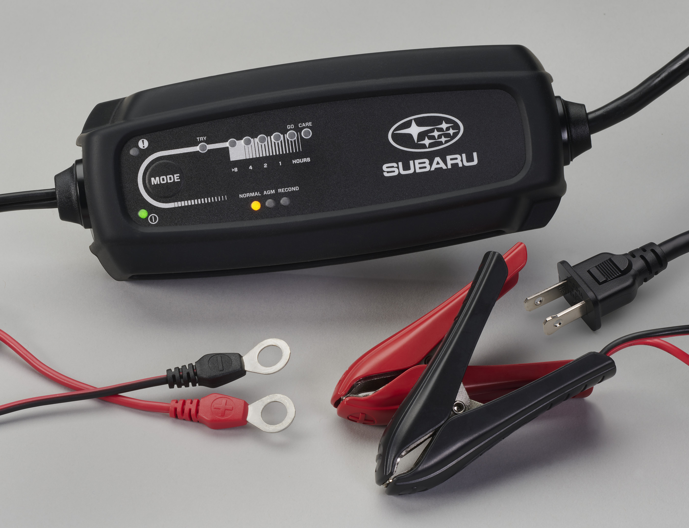 Close up of a Genuine Subaru battery being installed in a clean engine bay