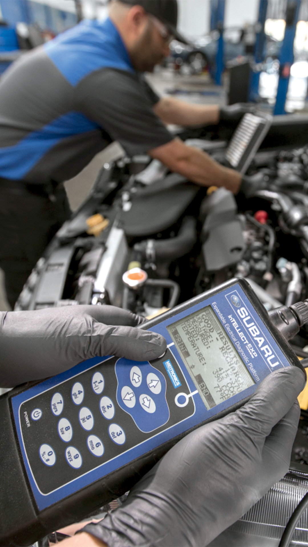 A certified Subaru technician performing a battery test with professional diagnostic equipment