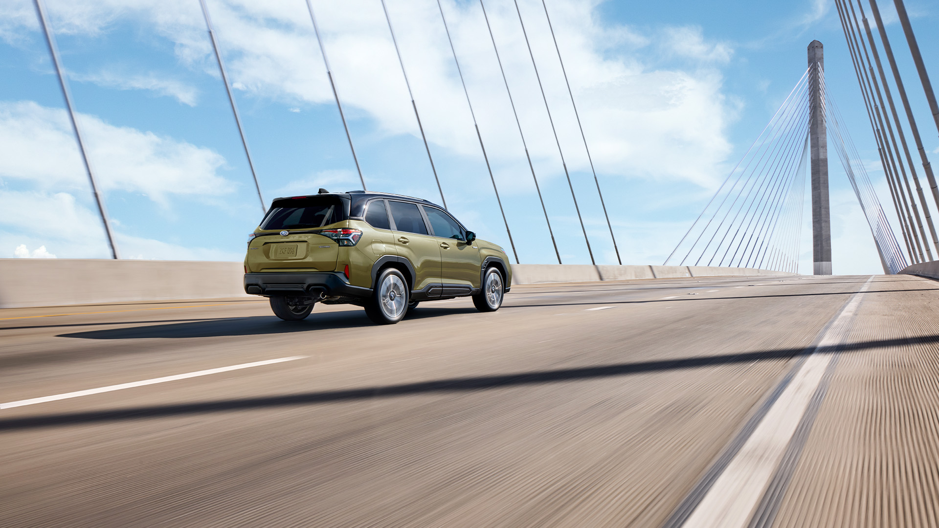 A sleek, modern 2026 Subaru Forester Hybrid parked in a scenic Missouri landscape during spring.
