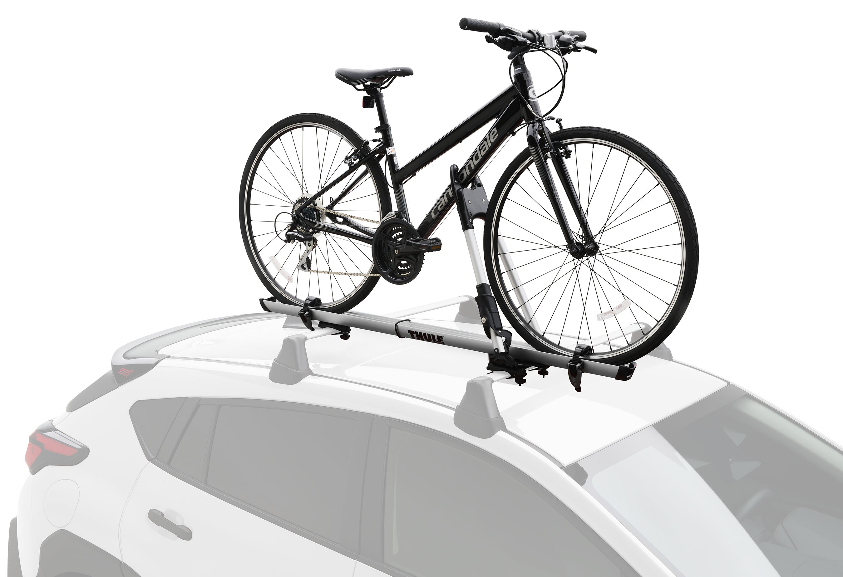 A Subaru Crosstrek equipped with Thule roof racks and a kayak carrier.