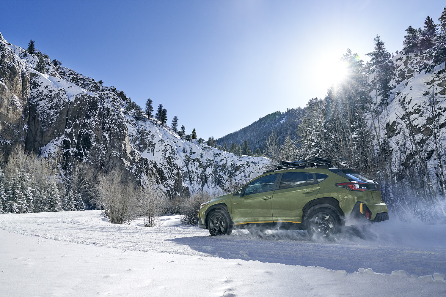 Close up of the Subaru X-MODE interface and the Crosstrek tackling a rugged path.