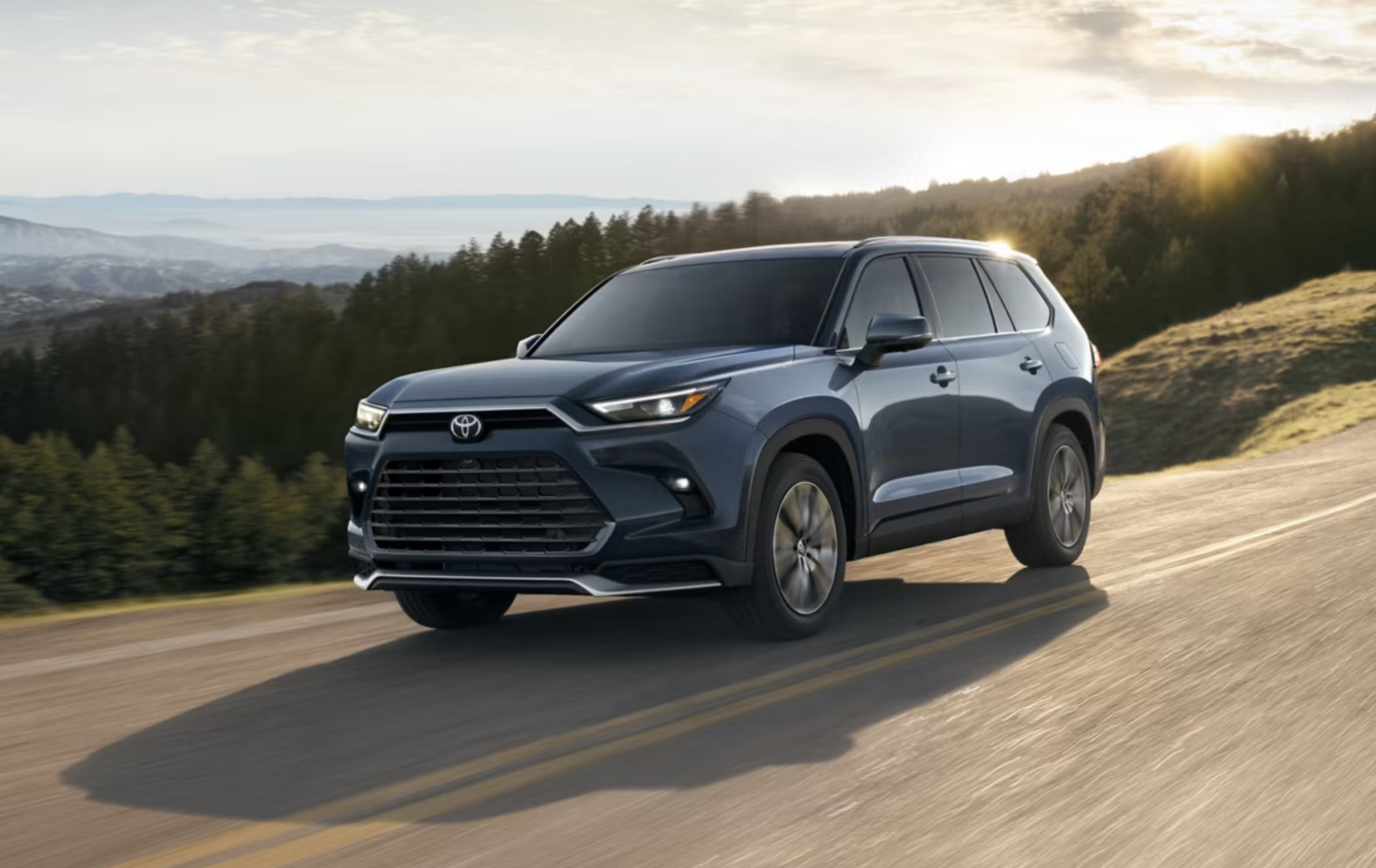 Toyota Grand Highlander driving on a coastal road
