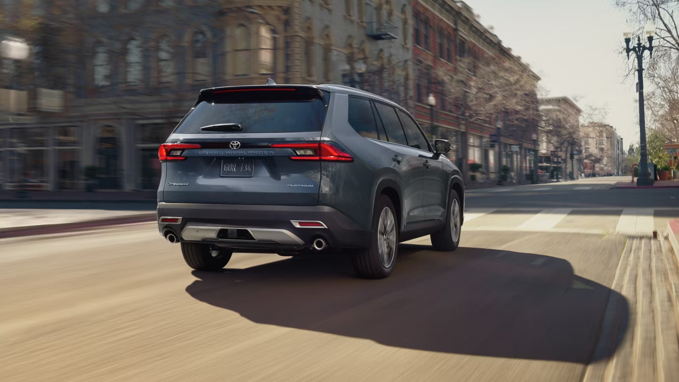 Toyota Grand Highlander driving through a city street