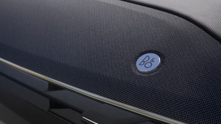 The premium B&O Sound System speaker grille located in the door panel.