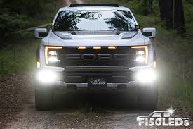 The LED fog lamps on a 2026 F-150 illuminating a dark road