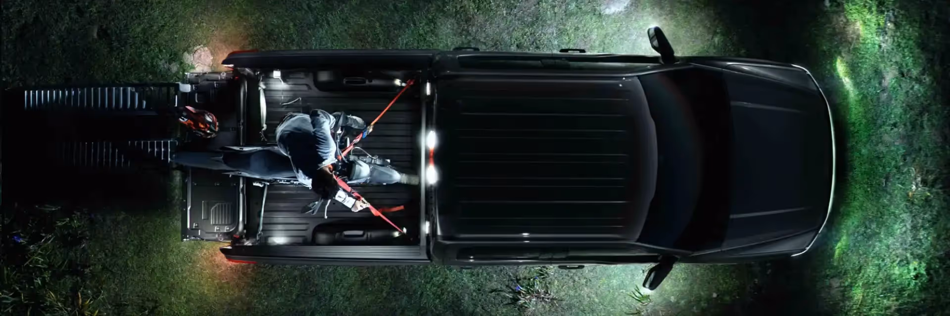 Zone lighting illuminating the perimeter of the truck in a dark campsite