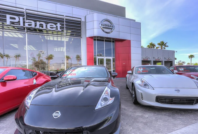 Nissan dealership with 370Z cars in black, red, and white.