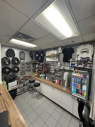 Store interior featuring automotive accessories and merchandise on display, refreshment fridge visible.