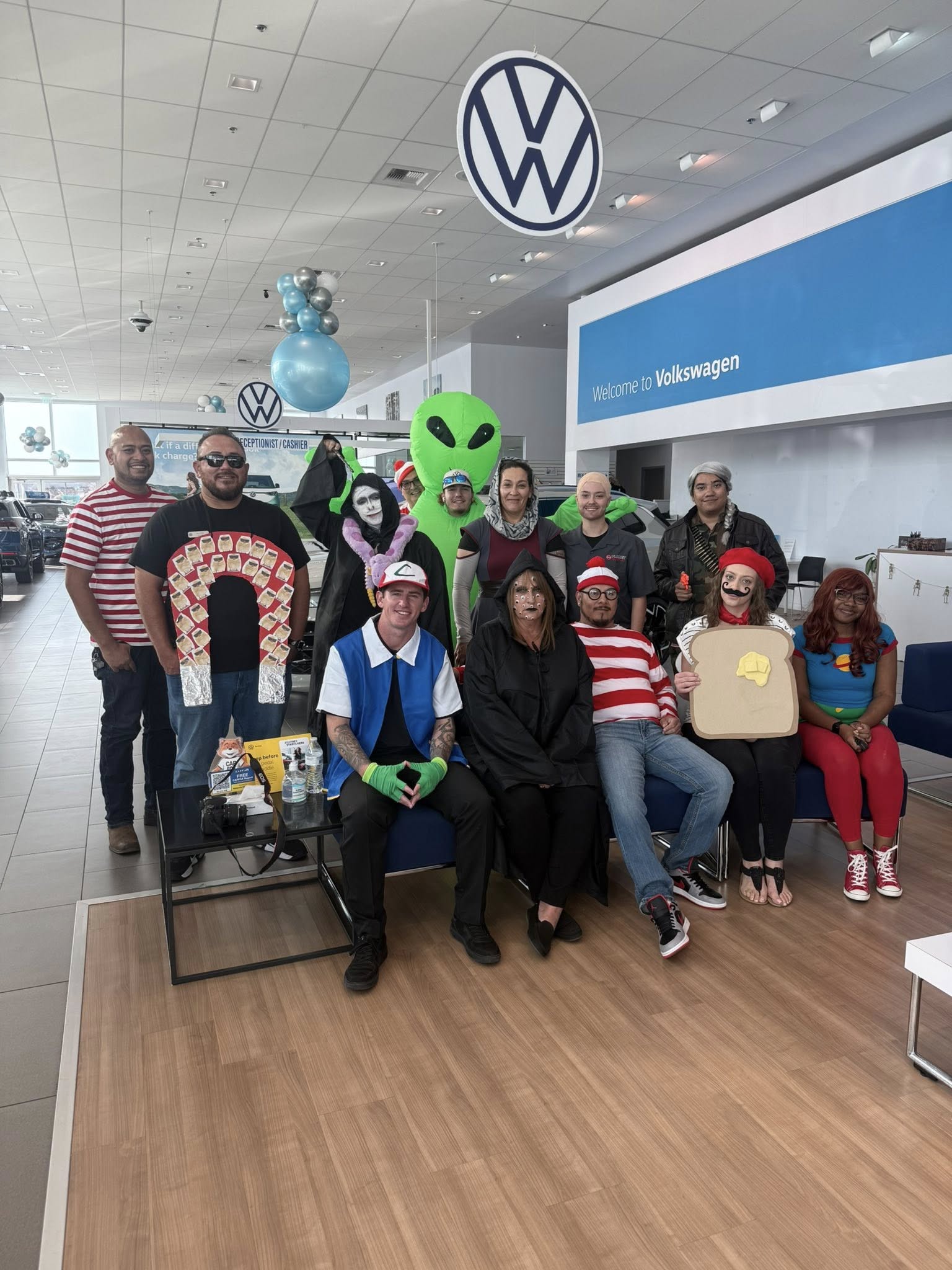 Volkswagen dealership staff in Halloween costumes.