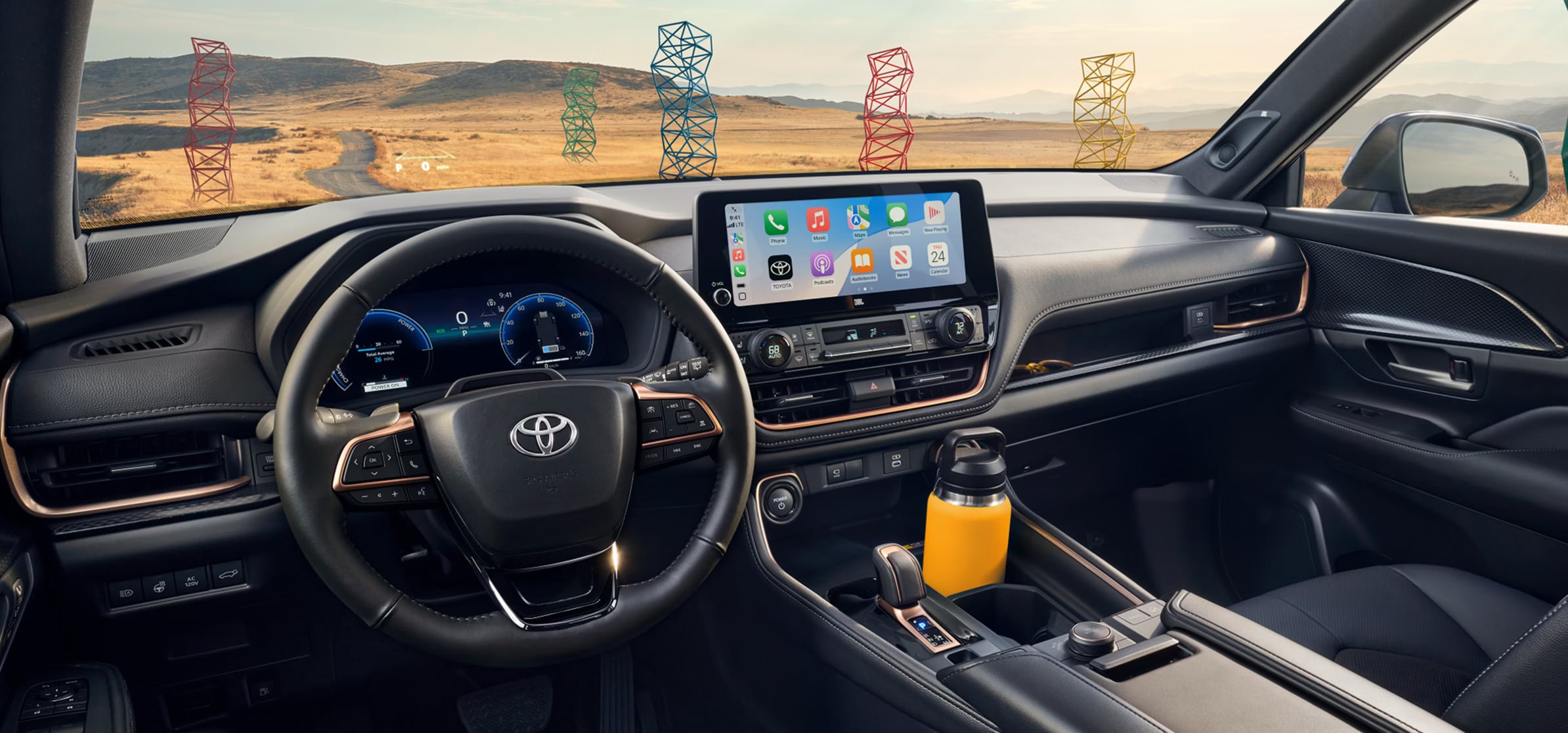 Dashboard and interior of a Toyota vehicle looking out over a colorful landscape.