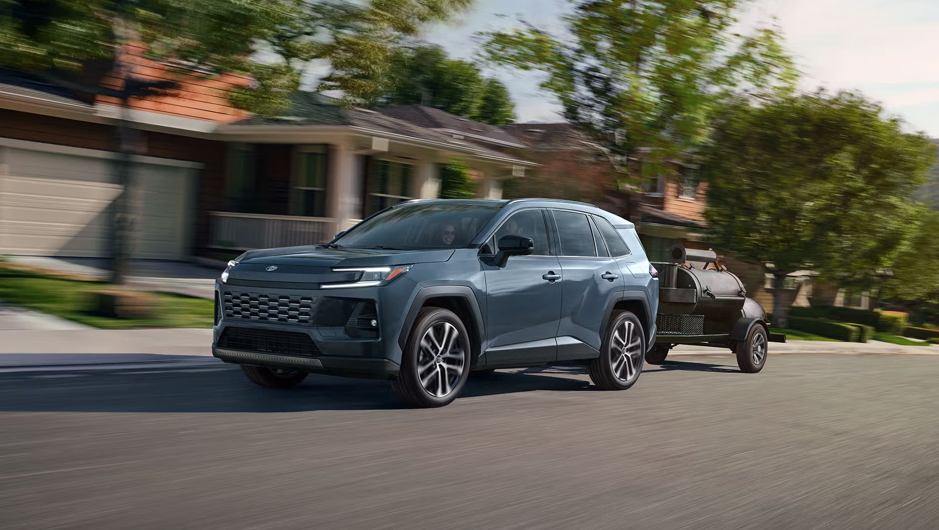 2026 Toyota RAV4 driving outdoors.