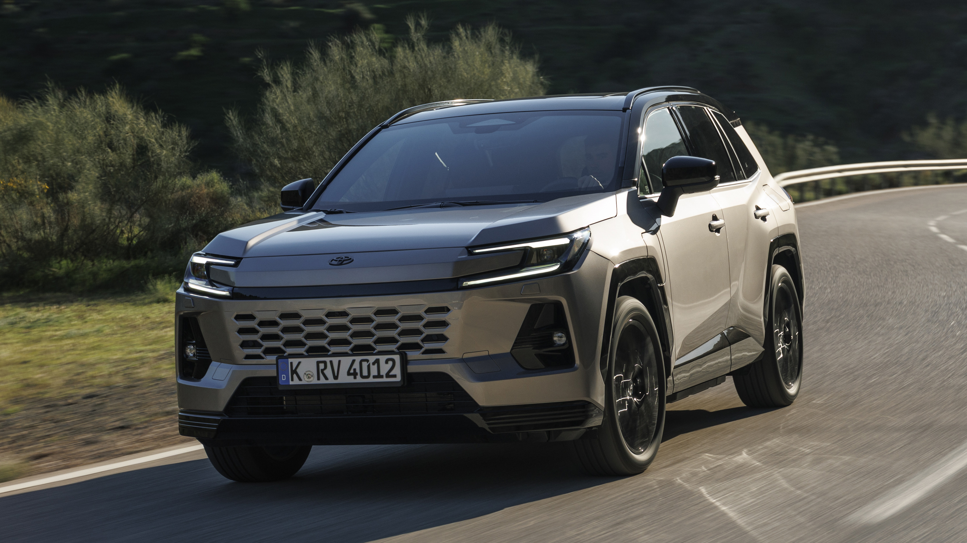 2026 Toyota RAV4 Plug-In Hybrid driving outdoors.