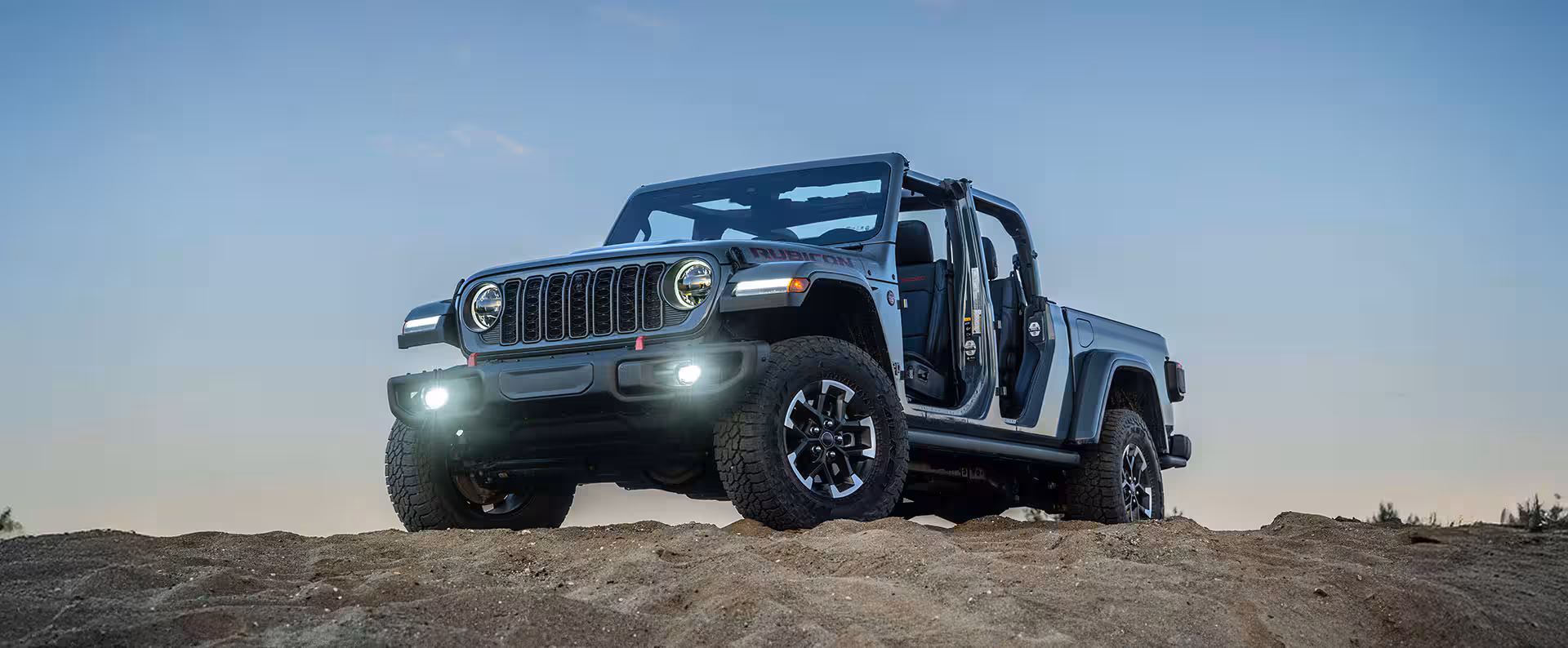 2026 Jeep Gladiator traveling through a rugged outdoor setting